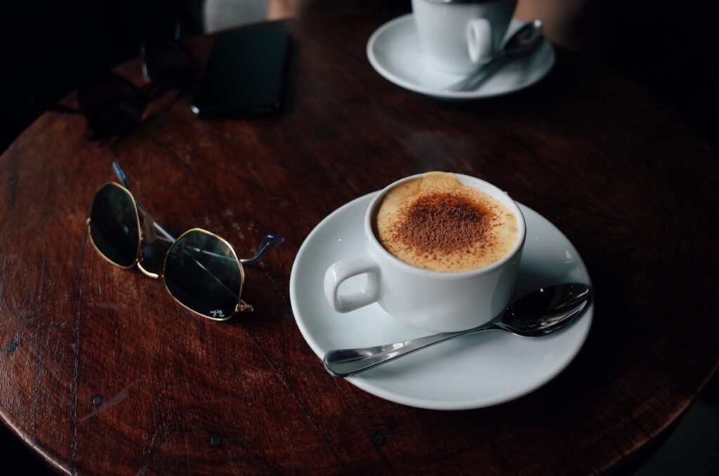 cup of coffee beside glasses