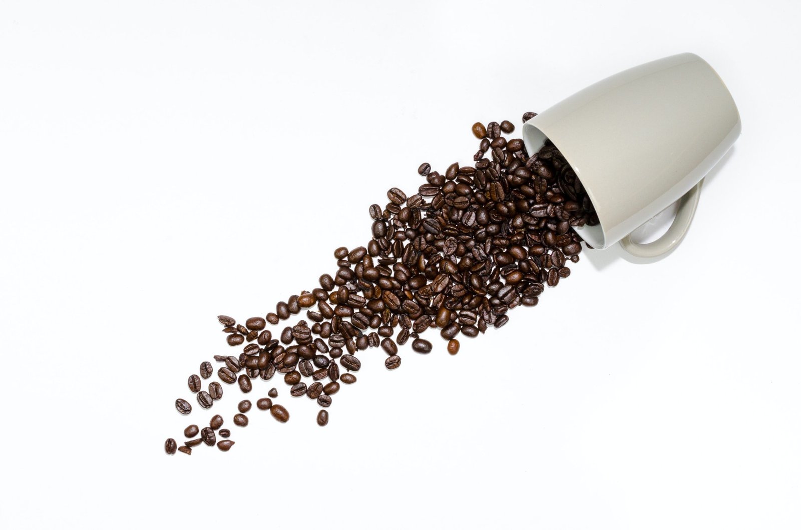 coffee beans falling on a white background