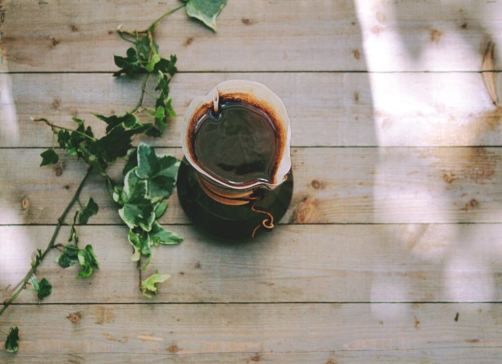 coffee on a wooden table with leaves on the side