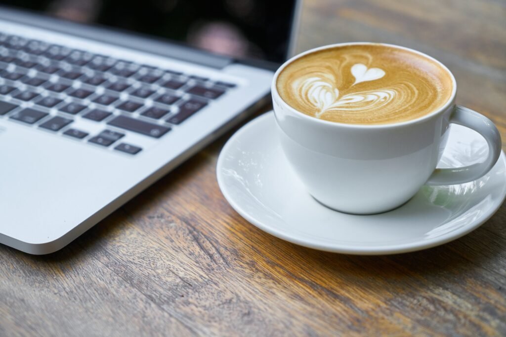 coffee beside a laptop
